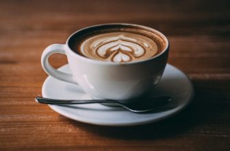 white ceramic teacup with coffee latte art