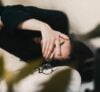 woman in black long sleeve shirt covering her face