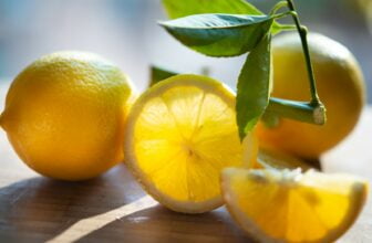 yellow lemon fruit on brown wooden table