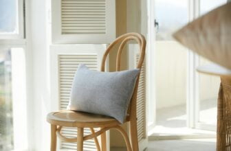 brown wooden chair with gray cushion