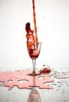 red liquid poured on wine glass