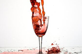 red liquid poured on wine glass