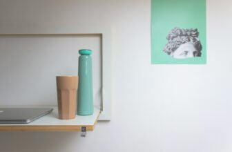 teal plastic pitcher on white wooden table